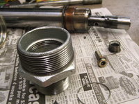 Improvised tool using a 1-1/2-inch IPS galvenized iron pipe nipple and 1-1/2 to 2-inch IPS galvenized iron bushing to seat fork seal and fork cover.